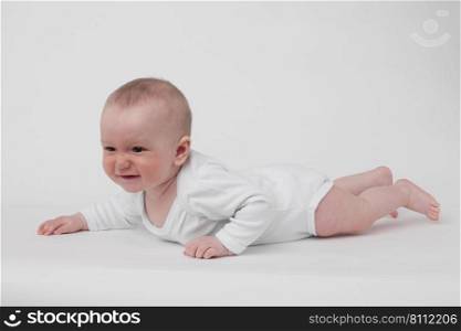 baby on a white background in a white pajamas. baby on a white background