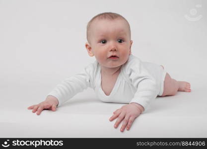 baby on a white background in a white pajamas. baby on a white background