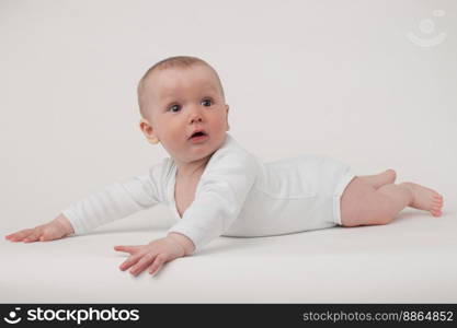 baby on a white background in a white pajamas. baby on a white background