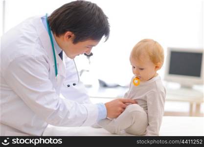 Baby on examination being checked by pediatric doctor