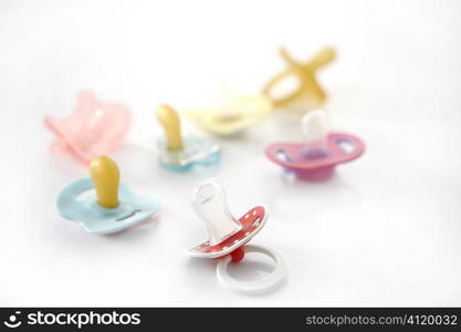 baby pacifier set over white background