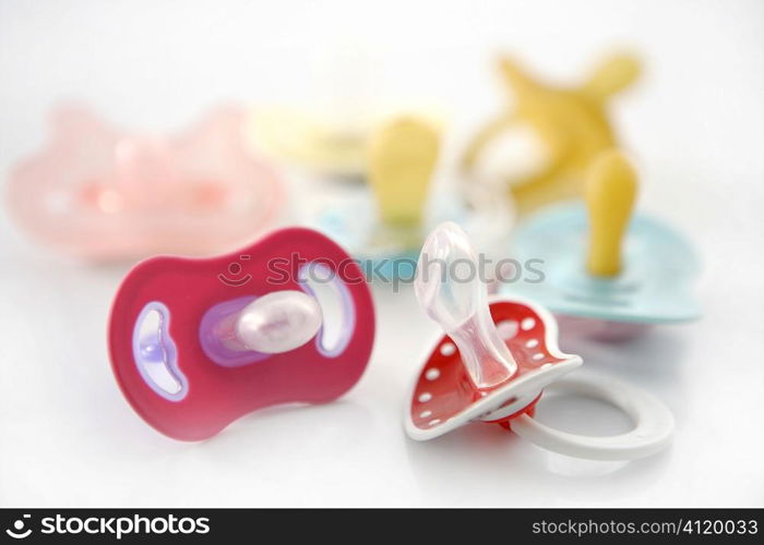 baby pacifier set over white background