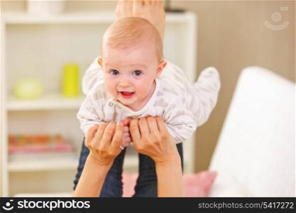 Baby playing with mother at home
