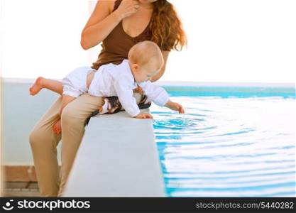 Baby playing with pool water&#xA;