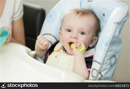 Baby playing with spoon while eating
