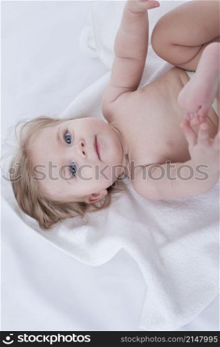 baby posing with white towel