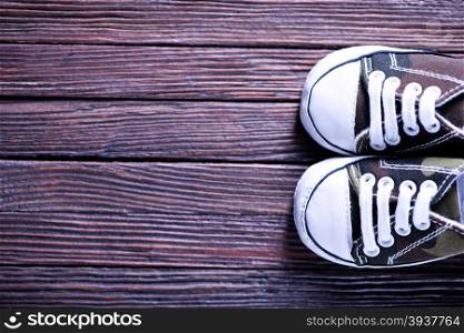 baby shoes on the wooden background, shoes on a table