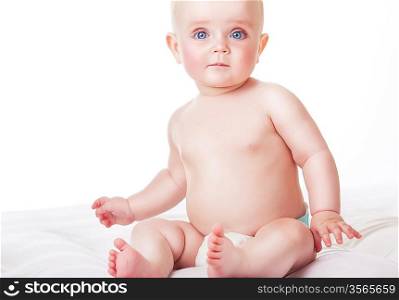 baby siting on white fabric