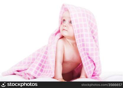 baby siting under towel