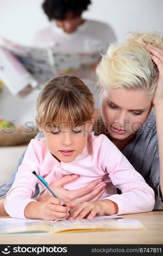 Baby-sitter and little girl doing homework