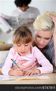 Baby-sitter and little girl doing homework
