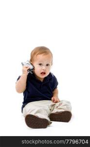 Baby sitting with phone in hand calling, isolated