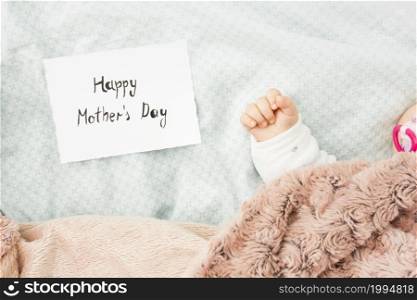 baby sleeping bed near happy mothers day inscription
