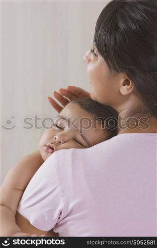 Baby sleeping in mothers arms