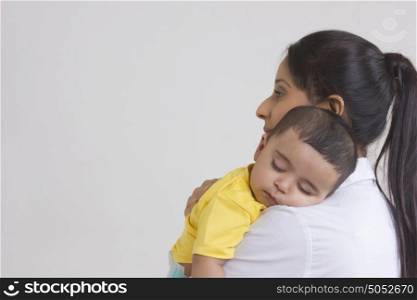 Baby sleeping in mothers arms