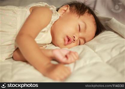 baby sleeping on bed in bedroom at home