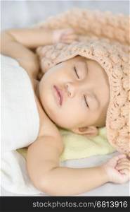 Baby sleeping on bed in the bedroom at home