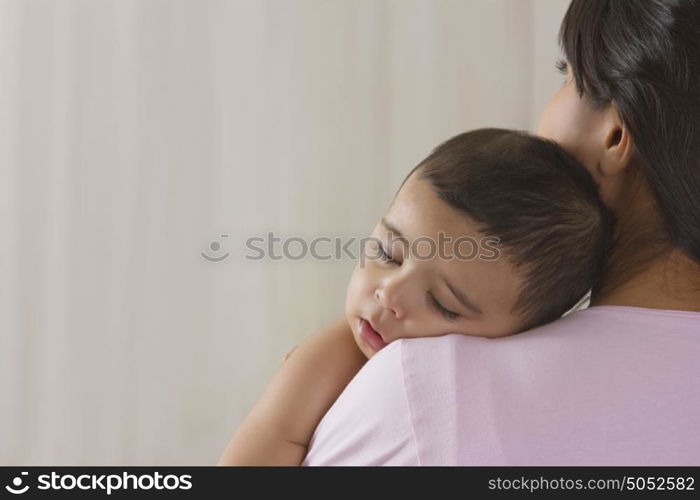 Baby sleeping on mothers shoulder