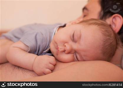 Baby sleeps on dad - tender care of his father