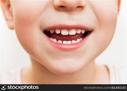 baby smile close. child teeth on a white isolated background.