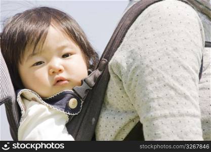 baby smiling in carrier