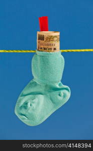 baby socks on clothesline with yen banknotes from japan.