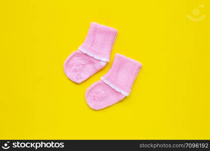 Baby socks on yellow background. Top view