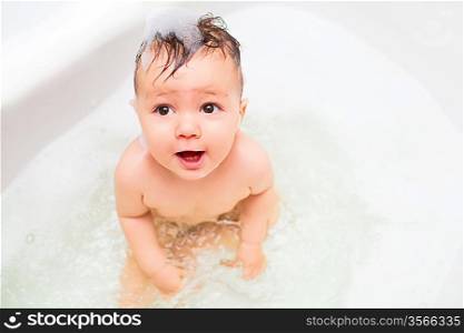 baby splashing in bath