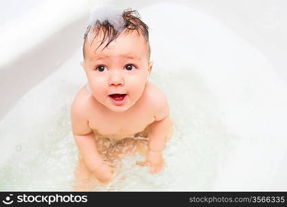 baby splashing in bath