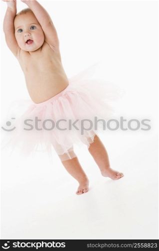 Baby standing in tutu
