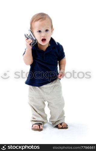 Baby standing with phone in hand calling and mouth open, isolated
