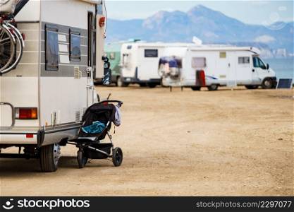 Baby stroller outdoors at caravan camping on beach, mediterranean coast in Spain. Family vacation.. Baby stroller at caravan outdoors on beach.
