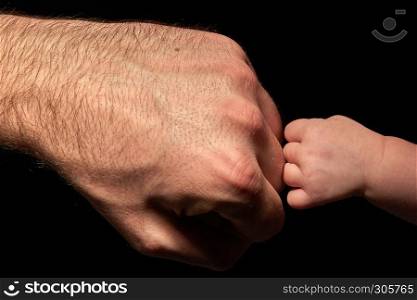 baby strong touching dad