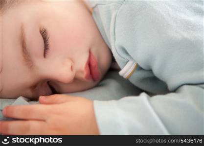baby toddler sleeping closed eyes relaxed in soft blue