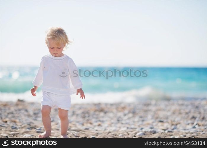 Baby walking on beach