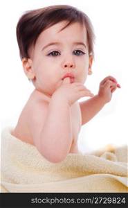 Baby with finger in mouth looking the camera in a white isolated background