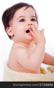 Baby with finger in mouth looking up in isolated background