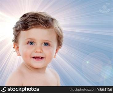 Baby with one years old doing funny gestures on a blue background