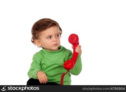 Baby with one years old playing with a red phone isolated on a white background