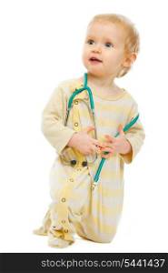 Baby with stethoscope looking in corner on white background