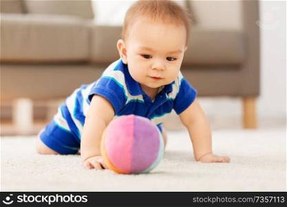 babyhood, childhood and people concept - sweet little asian baby boy playing with toy ball. sweet little asian baby boy playing with toy ball