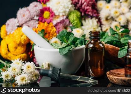 Bach Flower Remedies - Alternative Herbal Medicine. Dropper bottles, flowers, and mortar and pestle full of fresh mint . Bach Flower Remedies ? Alternative Herbal Medicine