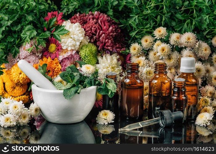 Bach Flower Remedies - Alternative Herbal Medicine. Dropper bottles, flowers, and mortar and pestle full of fresh mint . Bach Flower Remedies - Alternative Herbal Medicine