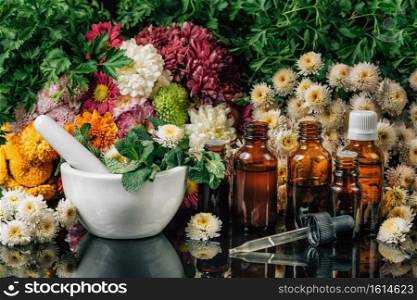 Bach Flower Remedies - Alternative Herbal Medicine. Dropper bottles, flowers, and mortar and pestle full of fresh mint . Bach Flower Remedies – Alternative Herbal Medicine