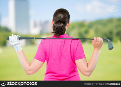 back is athletes with equipment for playing golf on a background of golf courses
