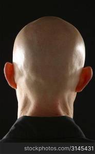 Back of a bald man&acute;s head.
