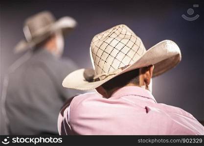 Back of Cowboy in Hat and Western Clothing at Rodeo in Montana