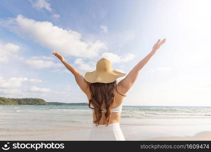 Back of views Attractive Asian young woman wearing white dress hug and enjoy with summer vacation on the beach feeling so happiness and cheerful,Travel in tropical beach in Thailand