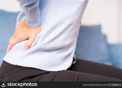 back pain at home. women suffer from backache. healthcare and medical concept