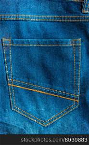 back pocket of blue jeans close-up